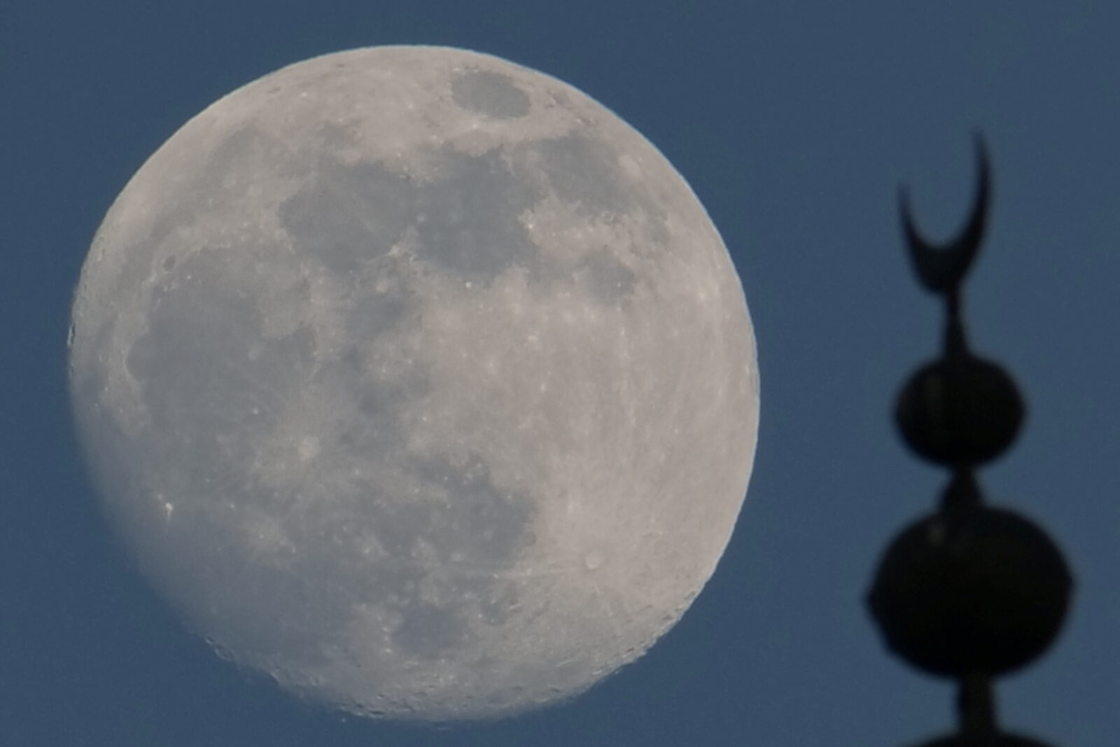 Full moon is seen behind David Tower in Jerusalem's Old City