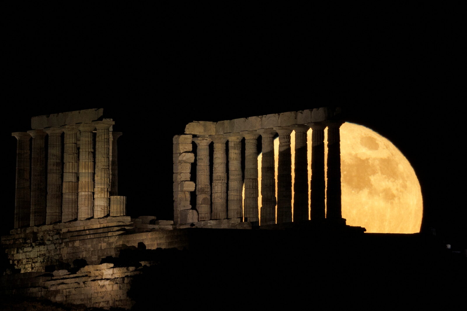 Strawberry Moon rises behind the Temple of Poseidon