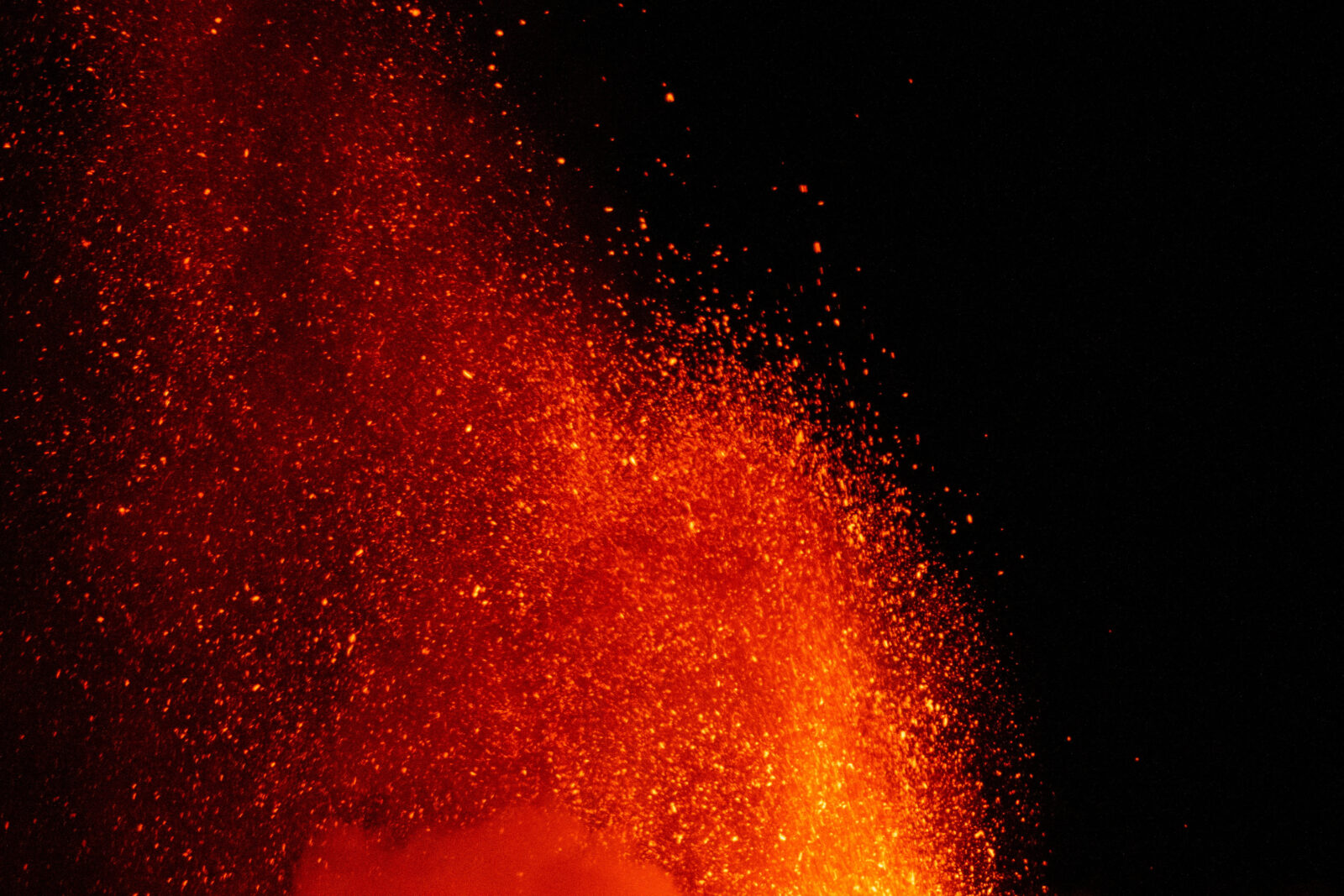 Mount Etna spurts red-hot lava into the night sky, as seen from Rocca Della Valle