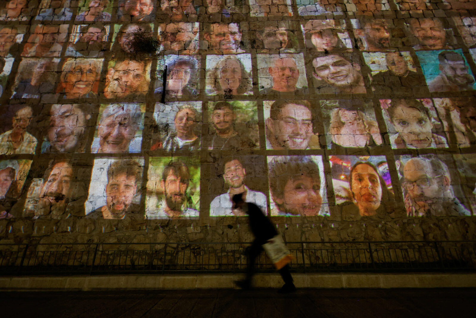 Faces of hostages kidnapped by Hamas are projected on the outer wall of the Old City of Jerusalem