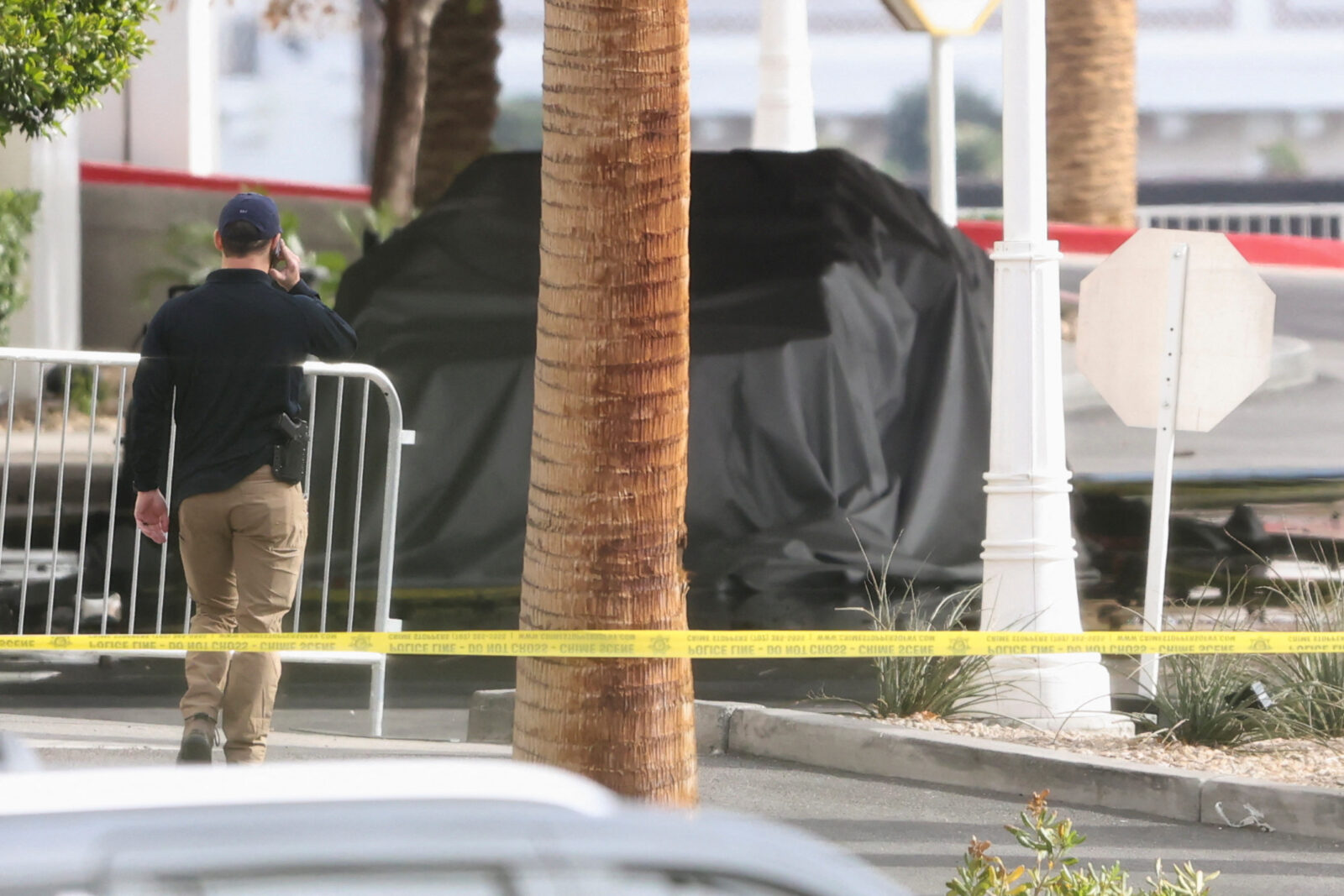 Firefighters work at the Tesla Cybertruck which burned at the entrance of Trump Tower in Las Vegas