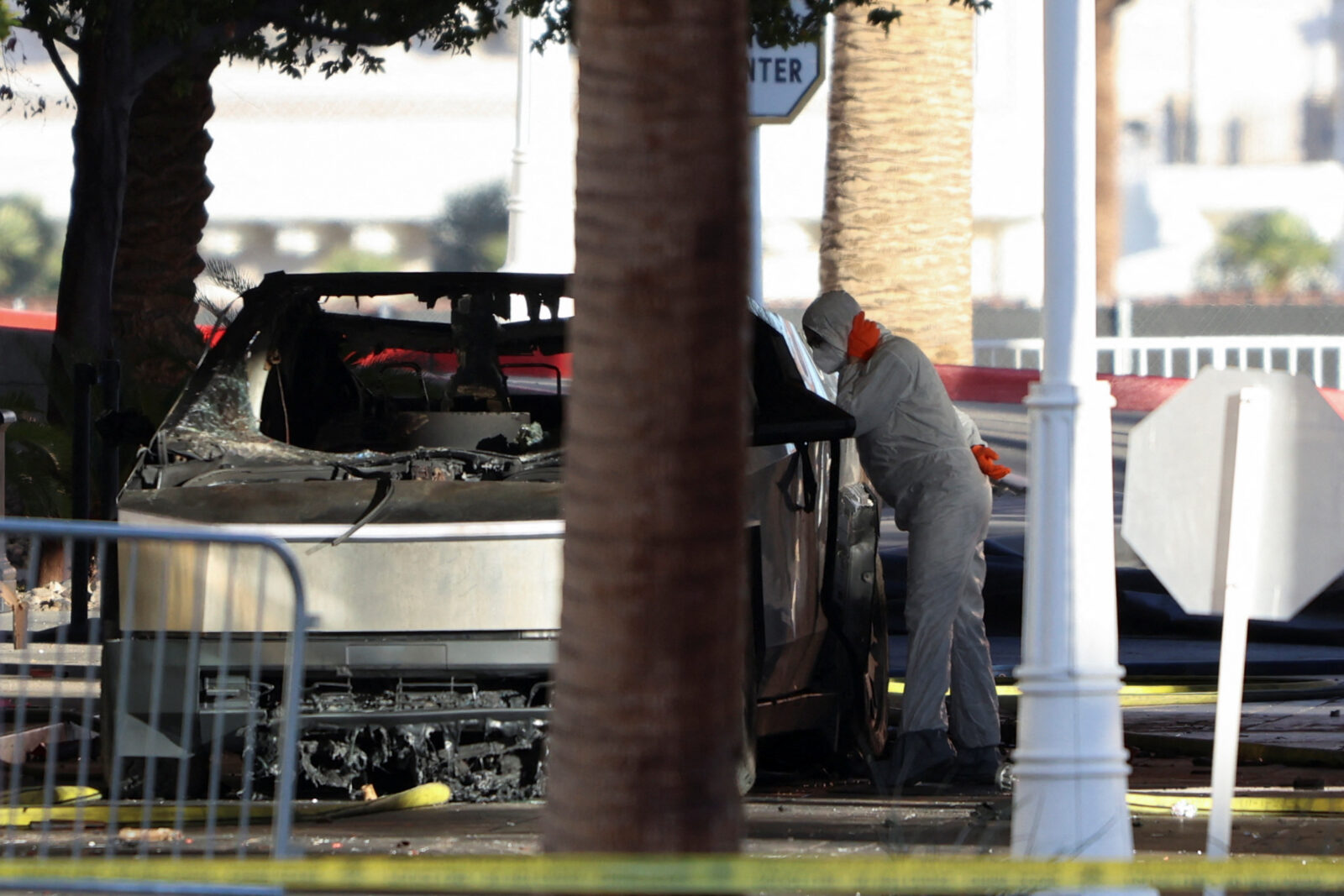 Firefighters work at the Tesla Cybertruck which burned at the entrance of Trump Tower in Las Vegas